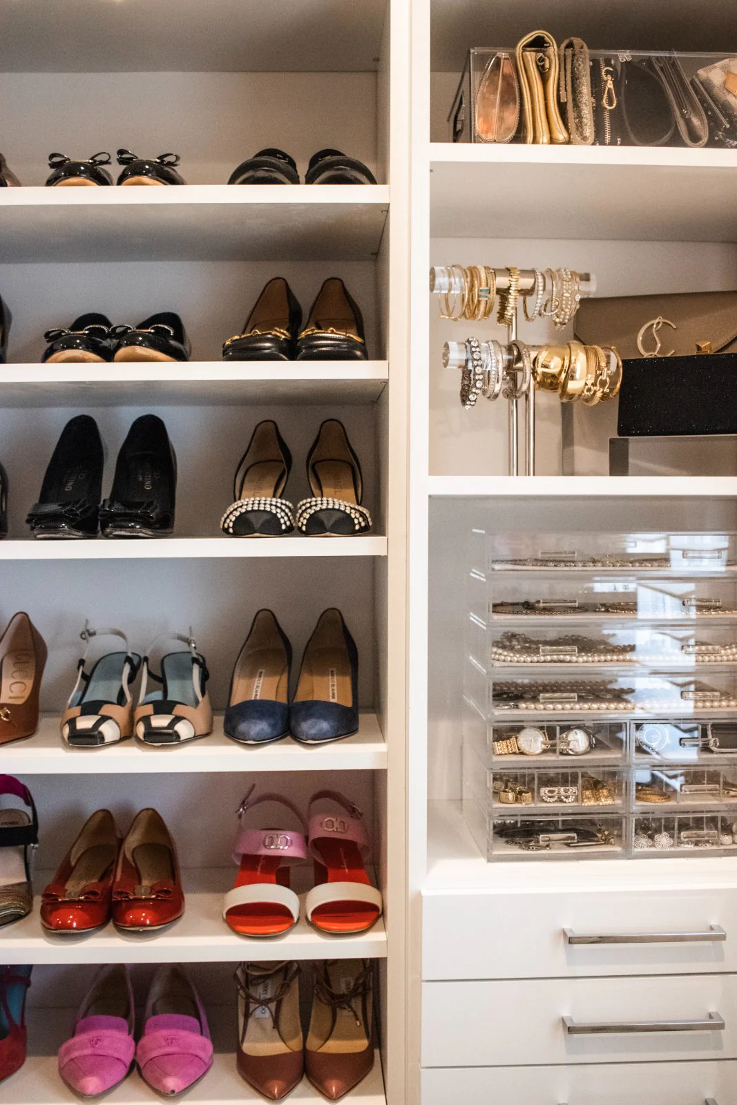 An organized shoe and jewelry wall in a client closet
