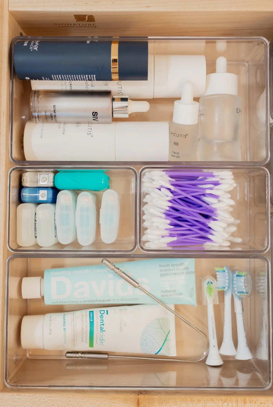 A divided bathroom drawer, skincare and dental sorted