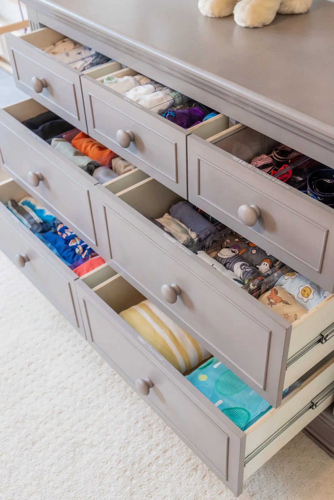 A child's dresser, every drawer divided and labeled