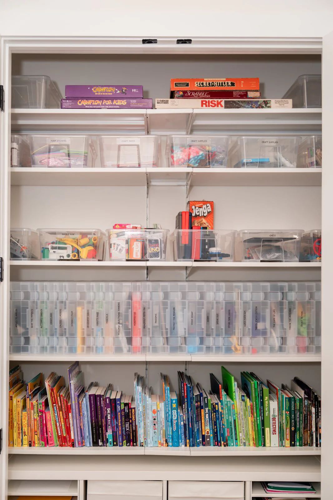 A games and books closet, labeled and sorted by color
